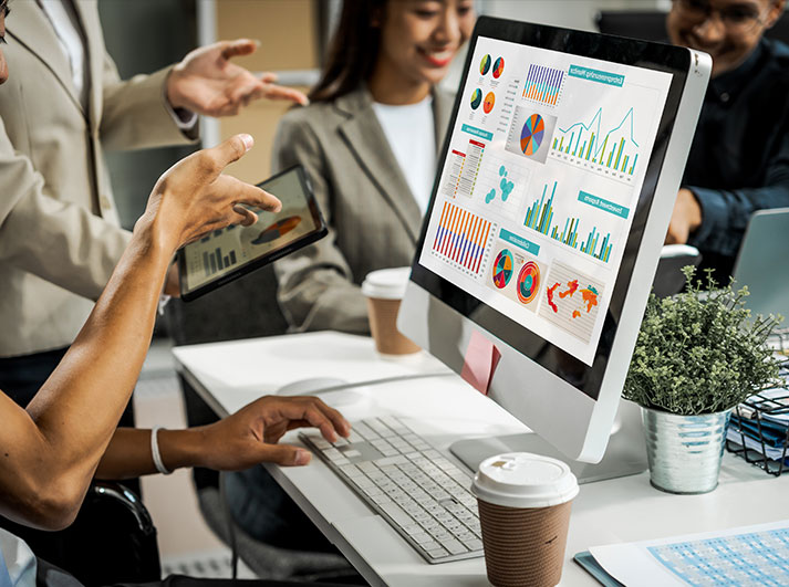 Team reviewing analytics dashboards on a desktop screen for SEO performance